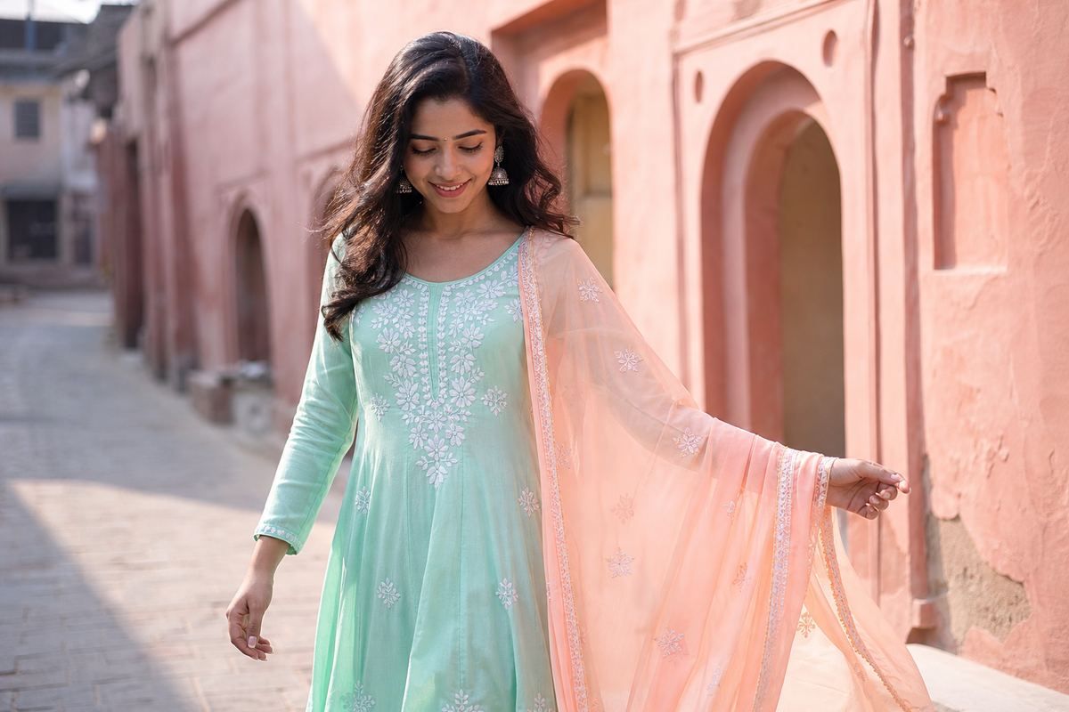 Young woman walking in a pink lane holding her dupatta out, a stylish photo pose for girls
